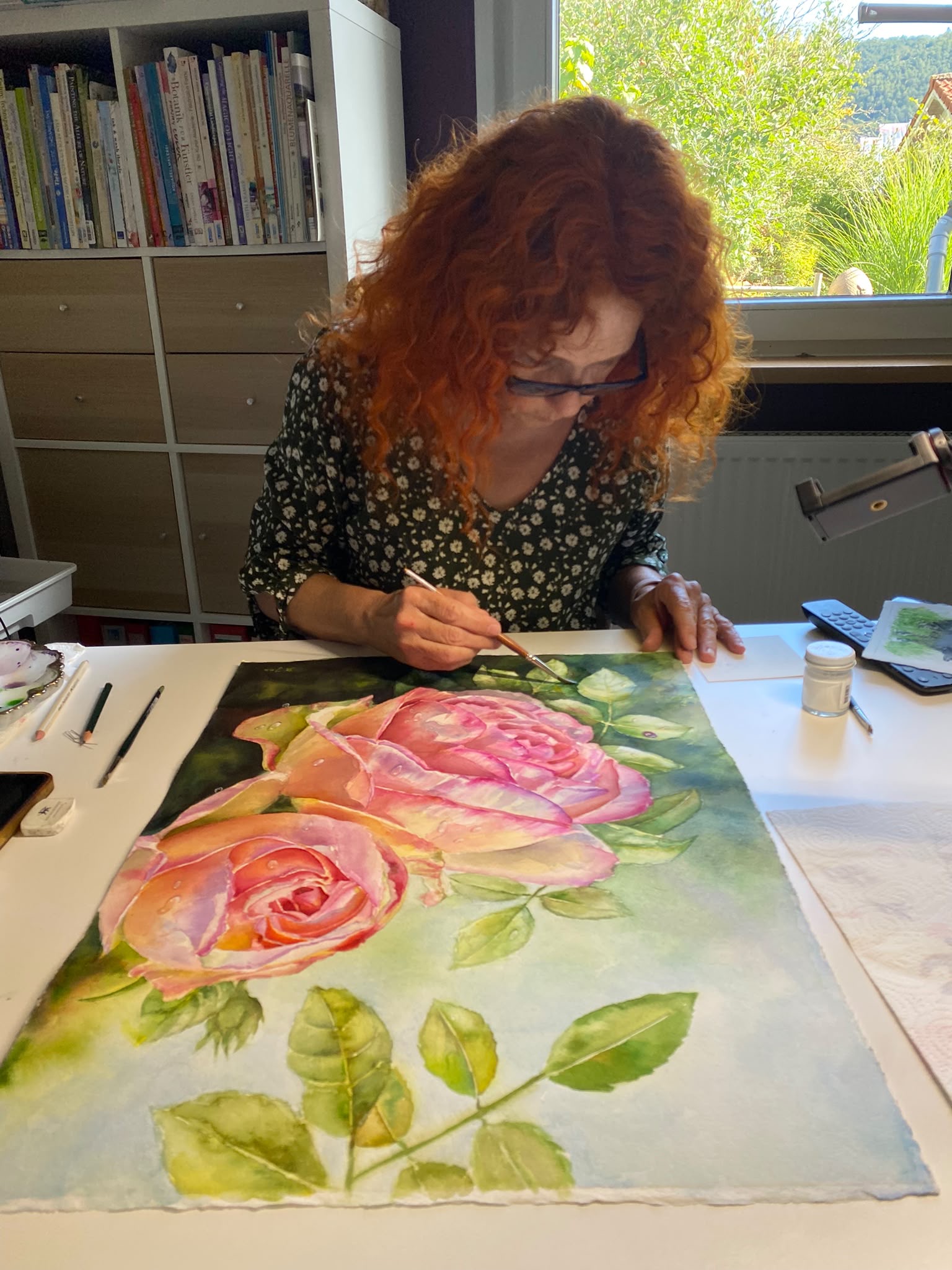 Doris Joa painting the Eden Rose watercolor at her studio table