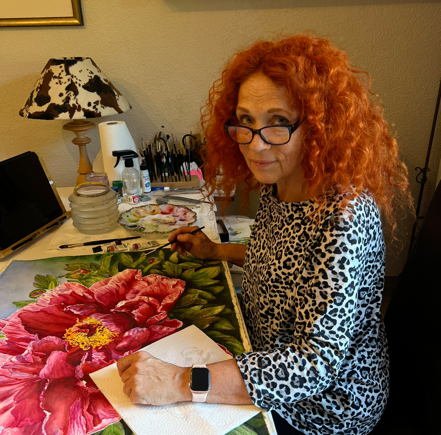 Doris Joa painting a red peony in her studio